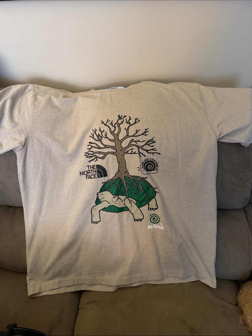 The North Face/Online Ceramics Beige Tee with Green Turtle & Brown Tree Graphics